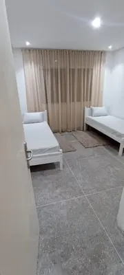 a room with two beds and a window at Appart RABAT AGDAL in Rabat