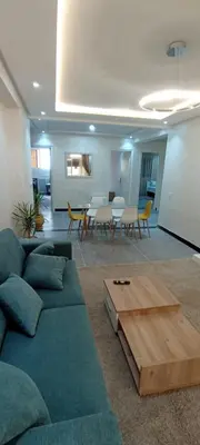a living room with a couch and a table at Appart RABAT AGDAL in Rabat