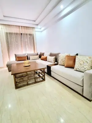 a living room with a couch and a coffee table at Appartement spacieux au cœur du Parc Proche plage Entre Casa et Rabat in Mohammedia
