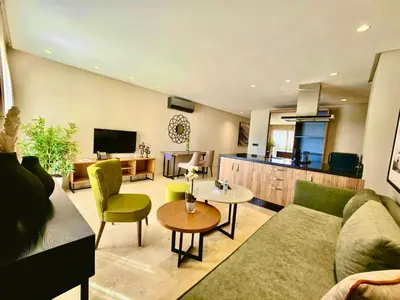 a living room with a couch and a table at AS Premium By Soho Hotels Maarif in Casablanca