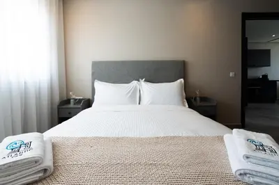 a bedroom with a large bed with towels on it at Atlantic View Appart'Hotel in Casablanca