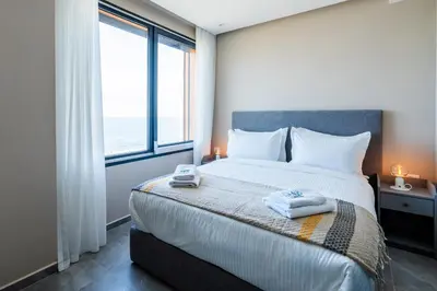 a bedroom with a bed with two towels on it at Atlantic View Appart'Hotel in Casablanca