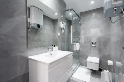 a bathroom with a white sink and a toilet at Atlantic View Appart'Hotel in Casablanca