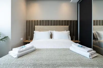 a bedroom with a large bed with towels on it at Atlantic View Appart'Hotel in Casablanca