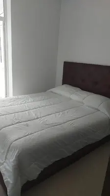 a large bed in a bedroom with a large window at Boulevard Anfa in Casablanca