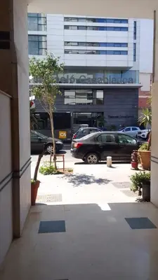a parking lot with cars parked in front of a building at Boulevard Anfa in Casablanca