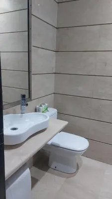 a bathroom with a white toilet and a sink at Boulevard Anfa in Casablanca