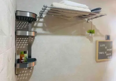 a bathroom with a towel rack on the wall at Bel Appartement Cosy dans le centre de Casablanca in Casablanca