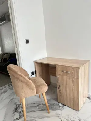 a desk with a chair next to a wooden cabinet at Chambre à Agdal Rabat dans un appartement partagé -two single beds- in Rabat