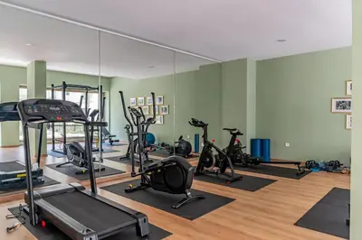 a gym with several tread machines and a mirror at AeroStudio in Nouaceur