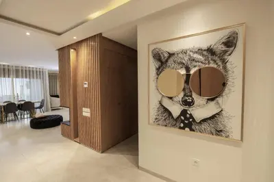 a painting of a wolf wearing glasses and a tie at Appartement raffiné dans un quartier de luxe in Rabat