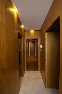 a hallway with wooden walls and a hallway with doors at Appartement raffiné dans un quartier de luxe in Rabat