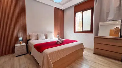 a bedroom with a bed with a teddy bear on it at Classic & Comfy Apartment, Steps to Sea & Tarmway in Rabat