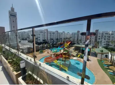 a view of a swimming pool from a balcony at Appartement Sidi Rahal in Sidi Rahal