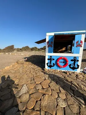 a drink booth on the beach with a cracked ground at Bleu Beach Résidence, Sidi Rahal in Sidi Rahal