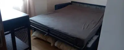 a bed sitting on a bed frame in a room at Bleu Beach Résidence, Sidi Rahal in Sidi Rahal
