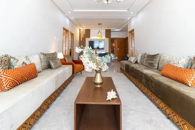 a living room with couches and a coffee table at Fun and Sun - Appartement de luxe - Dahomey Beach - Bouznika in Bouznika