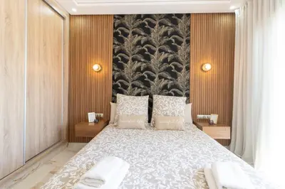 a bedroom with a large bed and a large wall at Fun and Sun - Appartement de luxe - Dahomey Beach - Bouznika in Bouznika