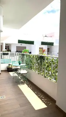 a balcony with a table and chairs on it at Modern apartment centrally located Parc Beach in Mohammedia