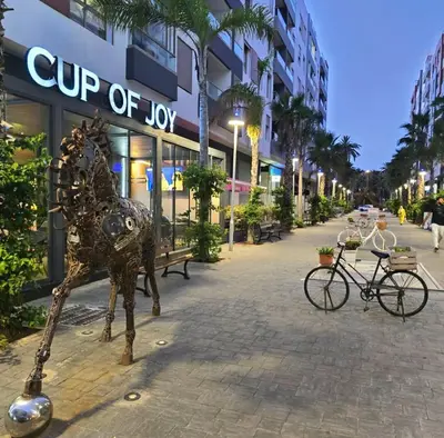 a statue of a dog on a sidewalk in front of a building at Modern apartment centrally located Parc Beach in Mohammedia