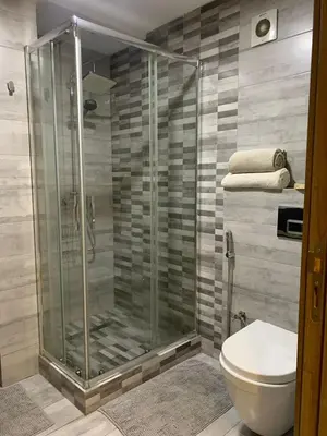a bathroom with a shower and a toilet at Modern apartment centrally located Parc Beach in Mohammedia