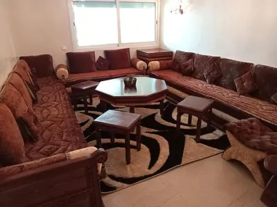 a living room with a large couch and tables at Sun Palace Palage des Sablettes D5 in Mohammedia