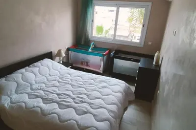 a bedroom with a bed and a window and a sink at Sun Palace Palage des Sablettes D5 in Mohammedia