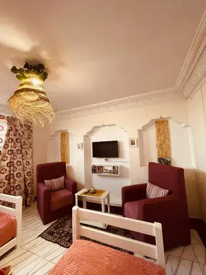 a living room with two chairs and a tv at Enchanting Studio in Casablanca in Casablanca