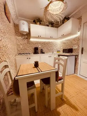 a kitchen with a table and chairs in a room at Enchanting Studio in Casablanca in Casablanca