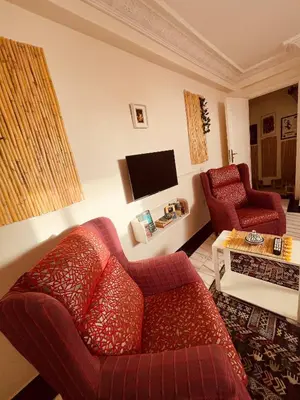a living room with a red couch and a tv at Enchanting Studio in Casablanca in Casablanca