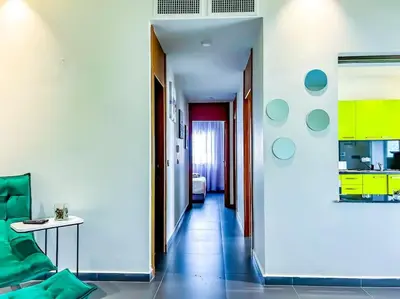 a room with a hallway with a table and a kitchen at Premium Appartement vue panoramique mer et piscine in Casablanca