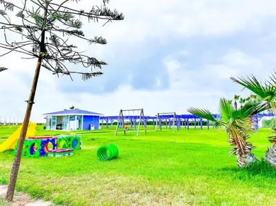 a park with a playground with swings at Premium Appartement vue panoramique mer et piscine in Casablanca