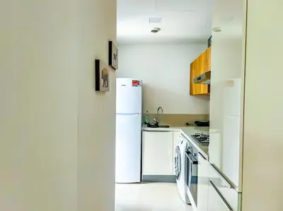 a kitchen with white appliances and a white refrigerator at Appartement prestige vue dégagée in Casablanca