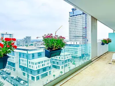 a balcony with three potted plants on a building at Appartement prestige vue dégagée in Casablanca