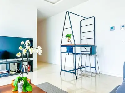 a living room with a blue table and chairs at Appartement prestige vue dégagée in Casablanca