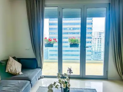 a living room with a couch and a large window at Appartement prestige vue dégagée in Casablanca
