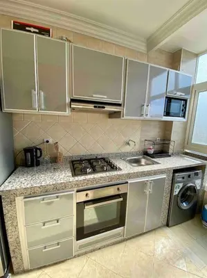 a kitchen with stainless steel cabinets and a stove top oven at Sweet Home in Casablanca