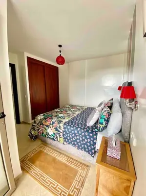 a small bedroom with a bed and a table at Sweet Home in Casablanca