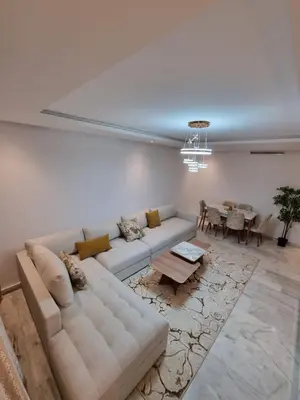 a living room with a couch and a table at Appartement - Dar Bouazza in Dar Bouazza