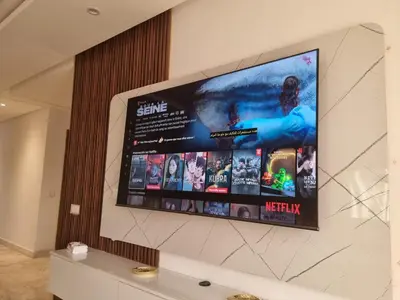 a flat screen tv hanging on a wall at Appartement - Dar Bouazza in Dar Bouazza