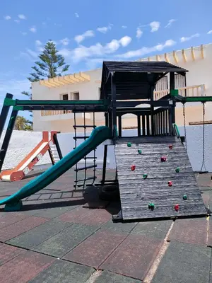 an outdoor playground with a slide and a slideintend at Appartement Sidi Rahal à Garden beach2 in Sidi Rahal