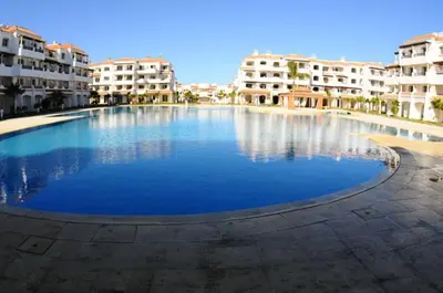 a large swimming pool in front of some buildings at Appartement Sidi Rahal à Garden beach2 in Sidi Rahal