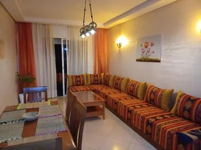 a living room with a couch and a table at Appartement Sidi Rahal à Garden beach2 in Sidi Rahal