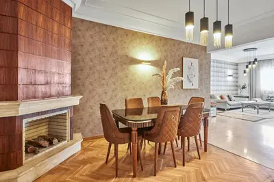 a dining room with a table and chairs and a fireplace at Spacious 2 Bed Flat with City Views and Free Parking in Casablanca
