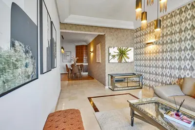 a living room with a couch and a glass table at Spacious 2 Bed Flat with City Views and Free Parking in Casablanca