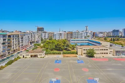 an empty basketball court in a city with buildings at Spacious 2 Bed Flat with City Views and Free Parking in Casablanca