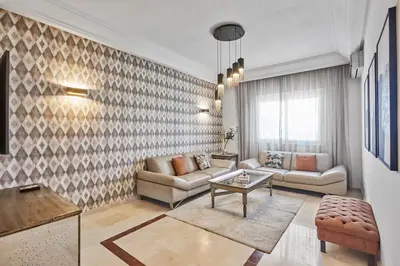 a living room with a couch and a table at Spacious 2 Bed Flat with City Views and Free Parking in Casablanca