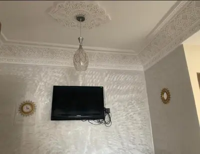 a flat screen tv hanging on a wall at Adorable Apartamento a 8 Min del Aeropuerto de Casablanca,WiFi Ultra Rapido y Parking Gratis in Derroua