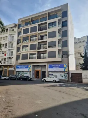 a white car parked in front of a building at charmant studio en plein cœur de maarif in Casablanca