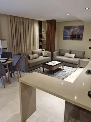 a large living room with couches and a table at charmant studio en plein cœur de maarif in Casablanca